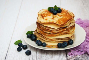 Plate with pancakes and blueberries