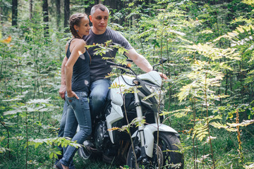 The motorcyclist and the girl in the forest