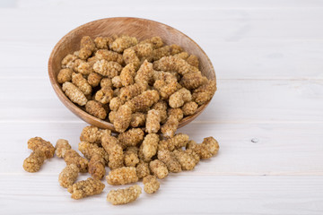 Dried White Mulberries Fruits In A Wooden Bowl Isolated On White Wooden Background, A Healthy And Popular Sweet Snacks In Iran And Turkey