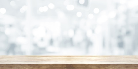 Empty wooden table top with blurred abstract background. Panoramic banner.