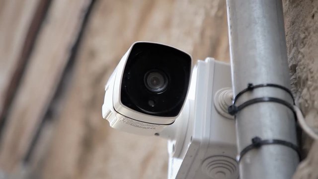 Handheld shot of a surveillance cam watching the street.

