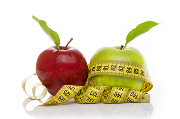 Green Apple and Red Apple with measuring tape on white background