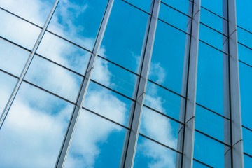 Clouds Reflected in Windows of Modern Office Building..