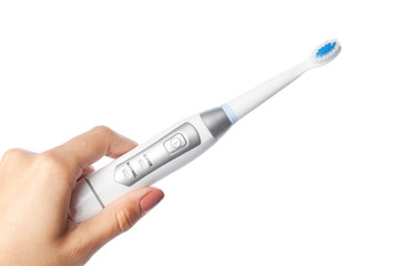 Obraz premium Woman hand holding a toothbrush isolated on white