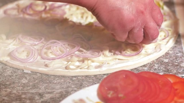 Chef hand making italian pizza at kitchen closeup. The process of cooking pizza. 4K
