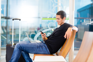 Man Using Smartphone In Airport Waiting Area