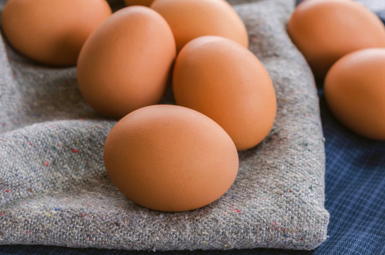 Close-up raw chicken eggs on fabric background