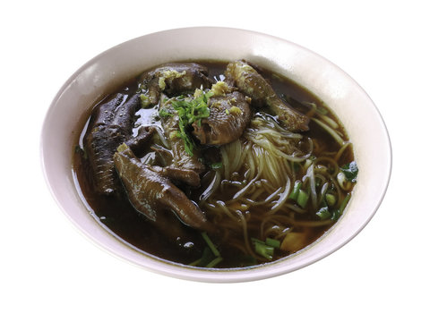 Thai food, Noodle with stew chicken's leg, foot and drumstick and choped vegetable coriander, spring onion. Isolated on white background. Clipping path include.