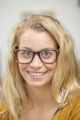 Portrait of beautiful blond woman with eyeglasses