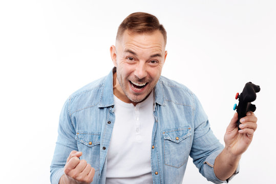 Overjoyed man being happy about victory in video game