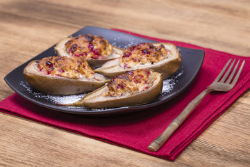 Homemade baked pears with cottage cheese, honey, red cranberries and walnuts, close up