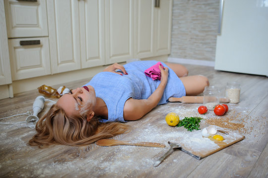 desperate housewife lying on the floor in her kitchen