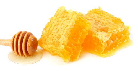 Honeycomb with honey dipper and honey isolated on white background