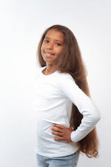 Pleasant pre-teen girl posing with hands akimbo