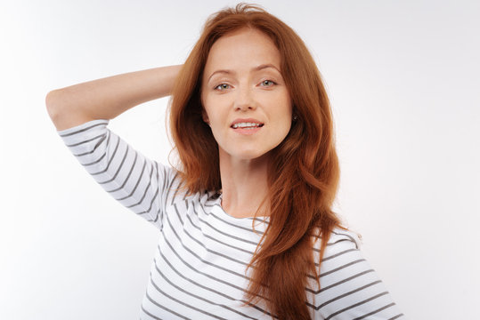 Ginger-haired woman posing on white background