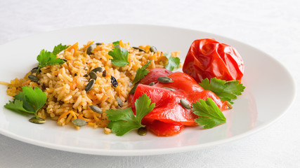 rice pilaf with roasted pumpkin seeds, tomato, and pepper decorated with cilantro