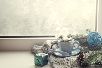 Obraz na płótnie Canvas the window with a cup of hot drink