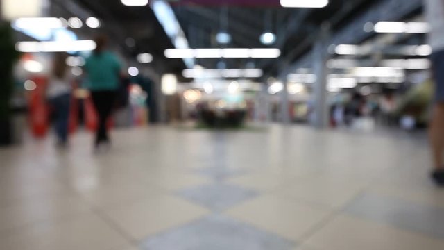 Blurred video of a people walking in a shopping mall. Blurred abstract background