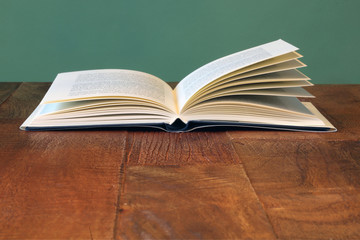 AUFGESCHLAGENES BUCH AUF TISCH