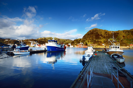 Norway marina with sailboats and fishingboats in a small village in the fjords