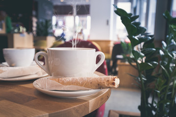 White cup of coffee at the cafe interior