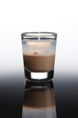 Vodka shot cocktail with irish cream and tabasco drop