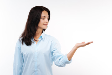 Charming dark-haired woman stretching her hand