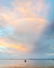 Rainbow and cloudy blue sky