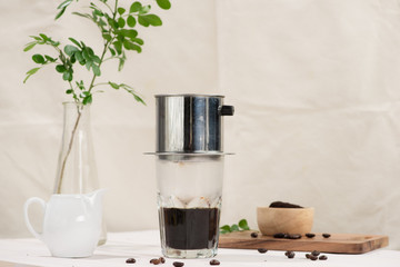 Coffee dripping in vietnamese style on wooden table