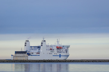 PASSENGER-CAR FERRY - ship sails into the sea from seaport