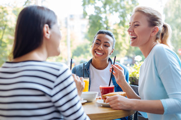 Female friends remembering good old days at lunch