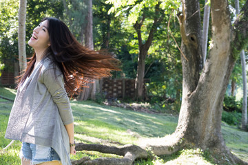 asian woman portrait. young female adult with natural make-up relax in park. attractive teenager smile with happiness in garden