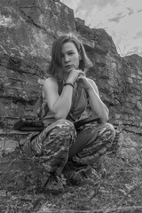 black and white, girl with arms sitting against the wall.