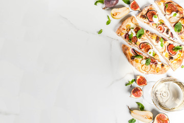 Autumn baking recipes. Sweet pie pizza or fruit focaccia with figs, pears, grapes, cream cheese, walnuts and mint. With white wine glass, on white marble background, copy space top view