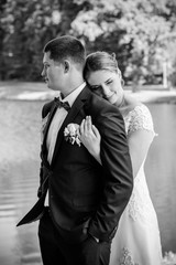 Wedding on a warm, sunny day in a beautiful European park. The groom is younger than the bride.Plus size woman- bride . A nice and beautiful couple have a happy day