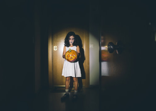 Malicious girl with pumpkin halloween