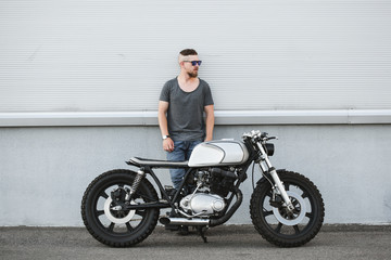 Fototapeta na wymiar Rider guy with classic style cafe racer motorcycle