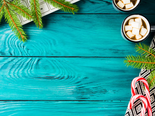 Winter christmas green background with hot chocolate, green branch and keyboard