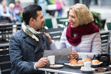 Mature couple at street cafe.