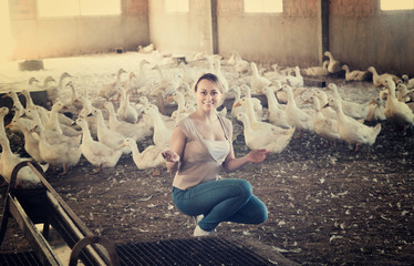 Girl with ducks on farm
