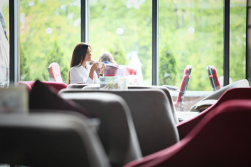 Image of a happy business woman enjoying the coffee-break