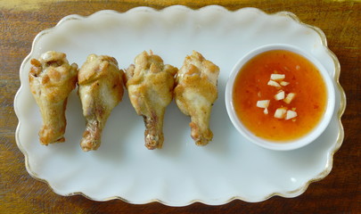 Fototapeta na wymiar fried chicken drumsticks with salt and pepper dipping sweet chili sauce
