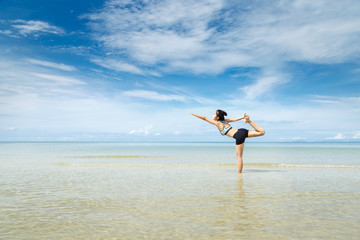 Fototapeta na wymiar Young woman Yoga at the beach
