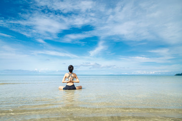 Young woman Yoga at the beach