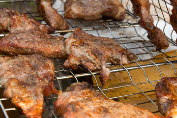 Close up view of juicy pork steak cooked on an open flame grill..