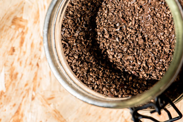 barley coffee in a glass jar, wooden background