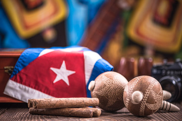 Items related to Cuba on wooden table