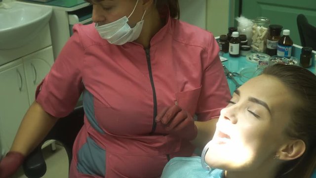 Cute young girl treats her teeth
