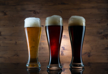Three glasses of different colored beer