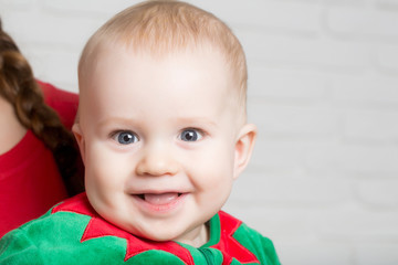 Elf kid in costume of santa.